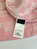Care and size label on pink hooded jacket with patchwork check fabric
