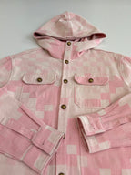 Pink hooded jacket close-up with chest pockets, gold buttons, and patchwork check pattern