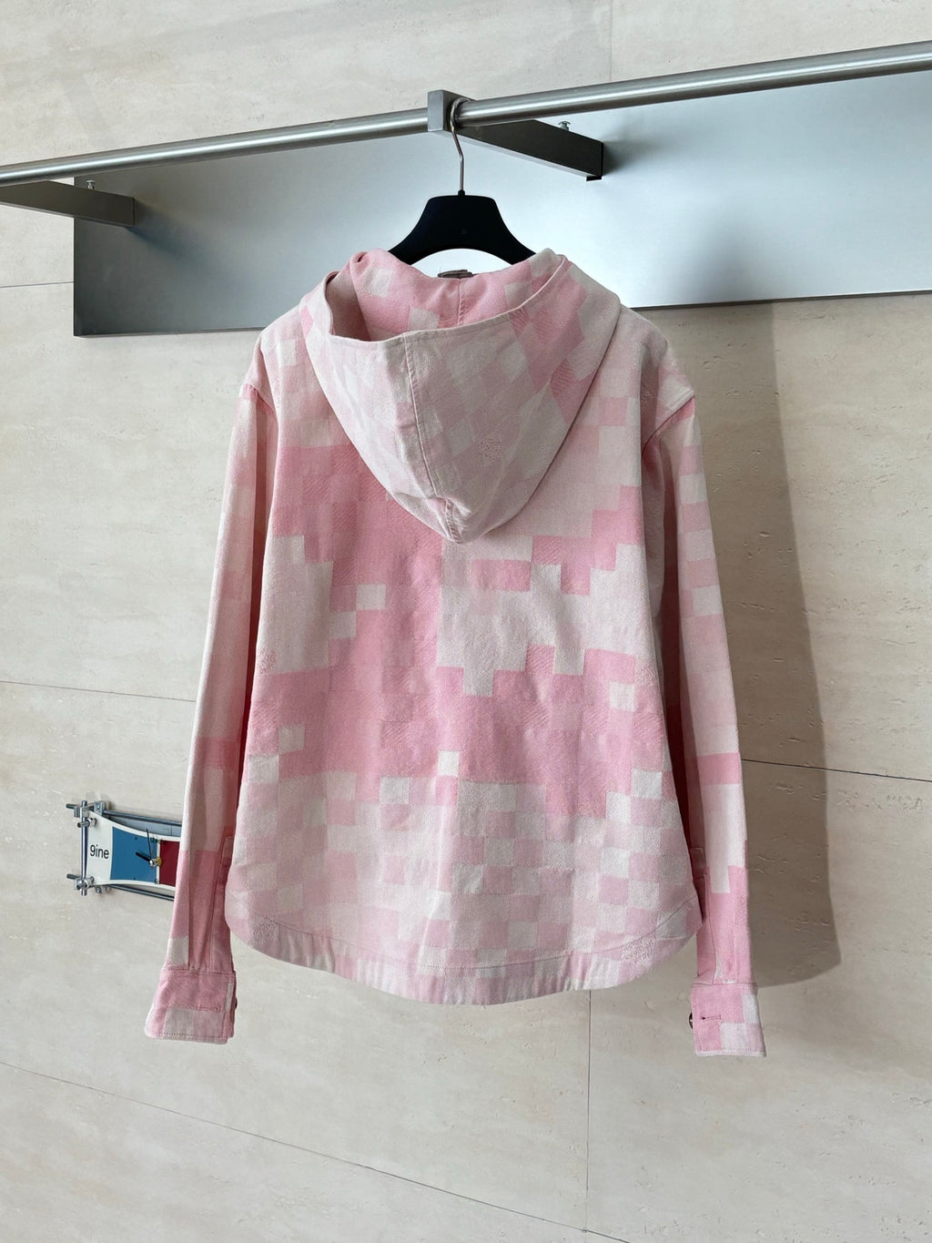 Pink hooded jacket with check pattern, front button placket, and long sleeves