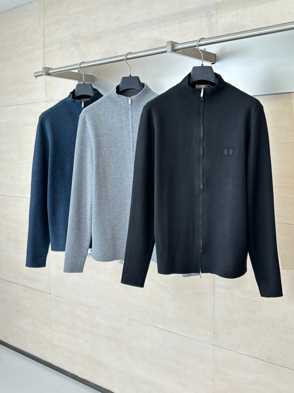Long-sleeve zip jackets on hangers, black and gray, stand collar
