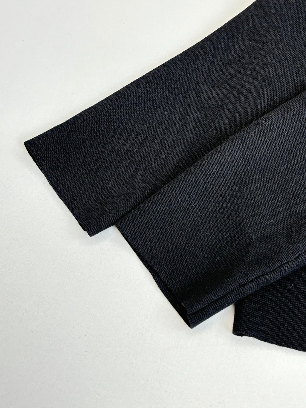 Black jacket sleeve cuff and folded fabric, long-sleeve zip style