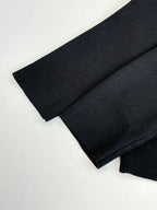 Black jacket sleeve cuff and folded fabric, long-sleeve zip style