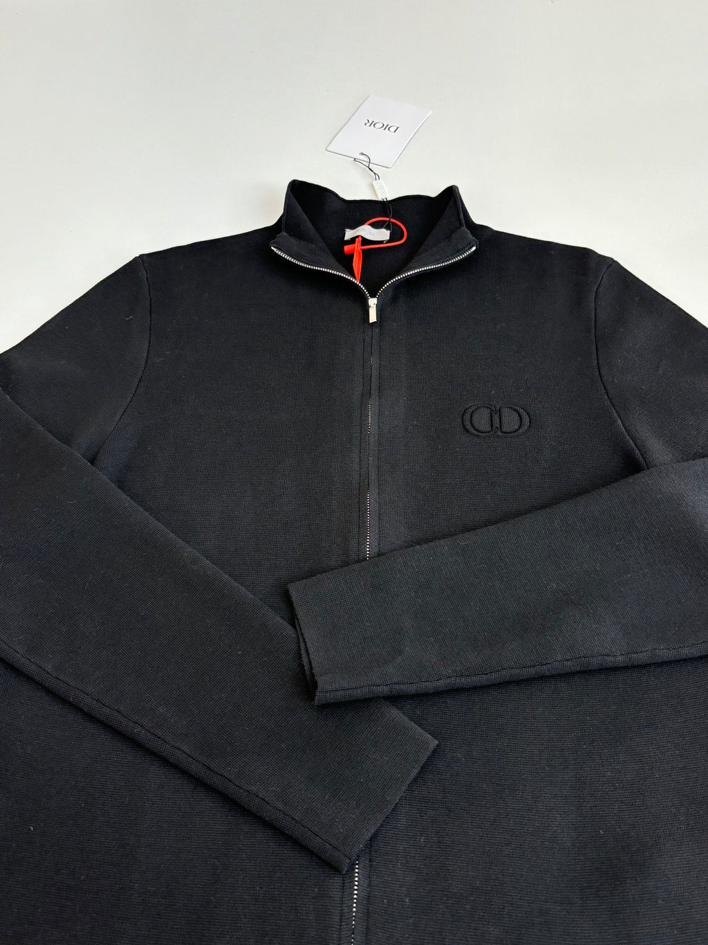 Dior long-sleeve zip jacket detail, black fabric with chest logo