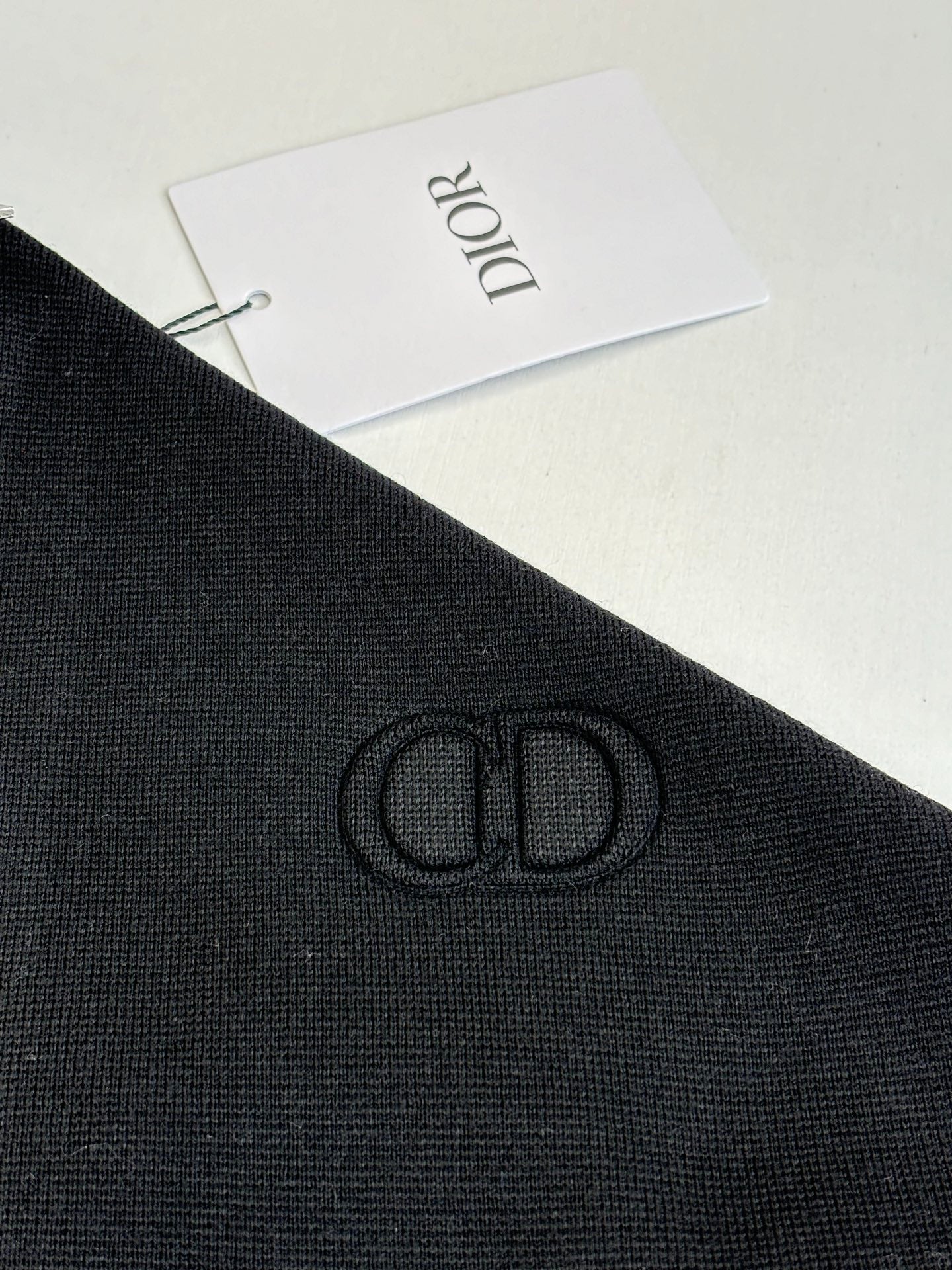 Black Dior long-sleeve jacket fabric with embroidered logo on sleeve