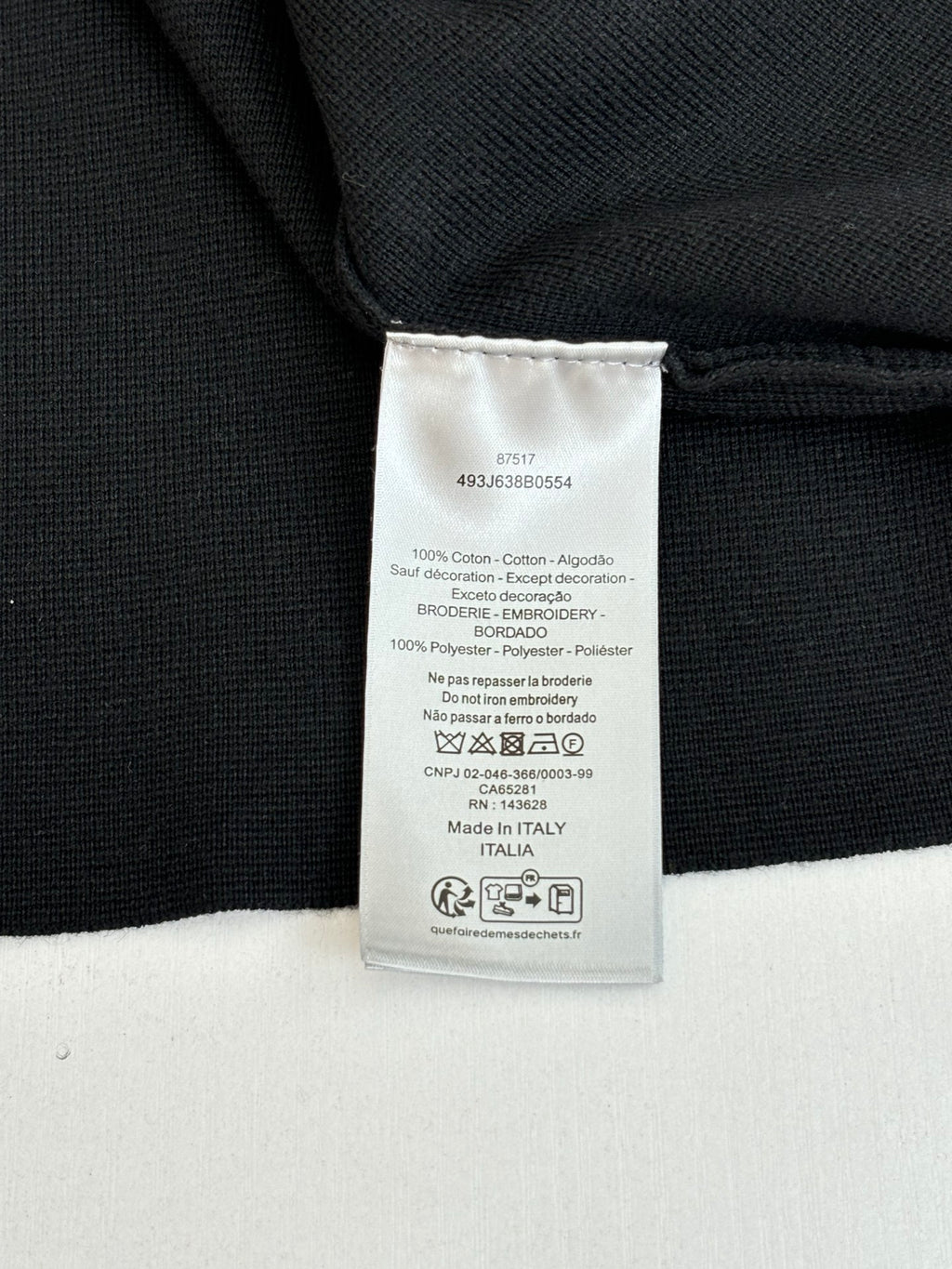 Black jacket interior care label tag at collar