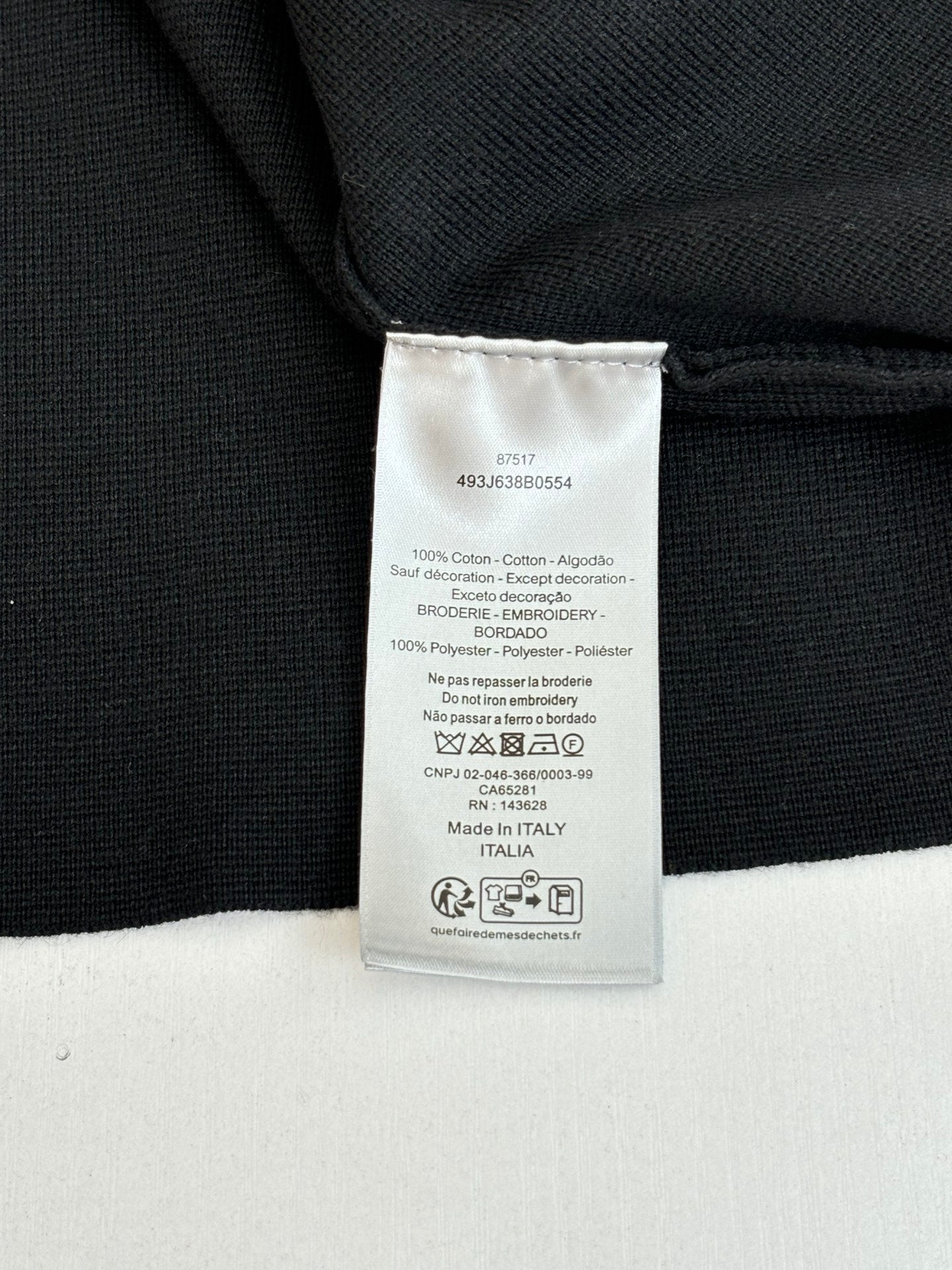 Black jacket interior care label tag at collar