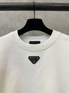 White sweatshirt chest with Prada triangle leather-look logo patch
