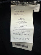Size and care label inside black sweatshirt, 100% cotton and cleaning instructions