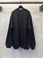 Black sweatshirt back view, crew neck and long sleeves with ribbed cuffs and hem