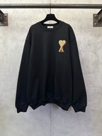 Black sweatshirt with gold A heart logo on front, crew neck and long sleeves