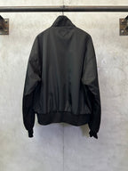 Black back view bomber jacket with stand collar and ribbed hem