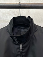 Black jacket collar and center zipper with inner lining visible at neckline
