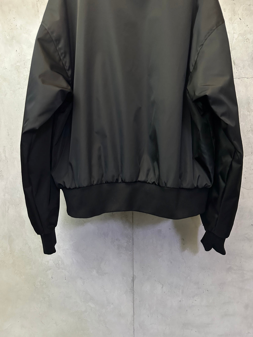 Black bomber jacket with ribbed cuffs and elastic hem band