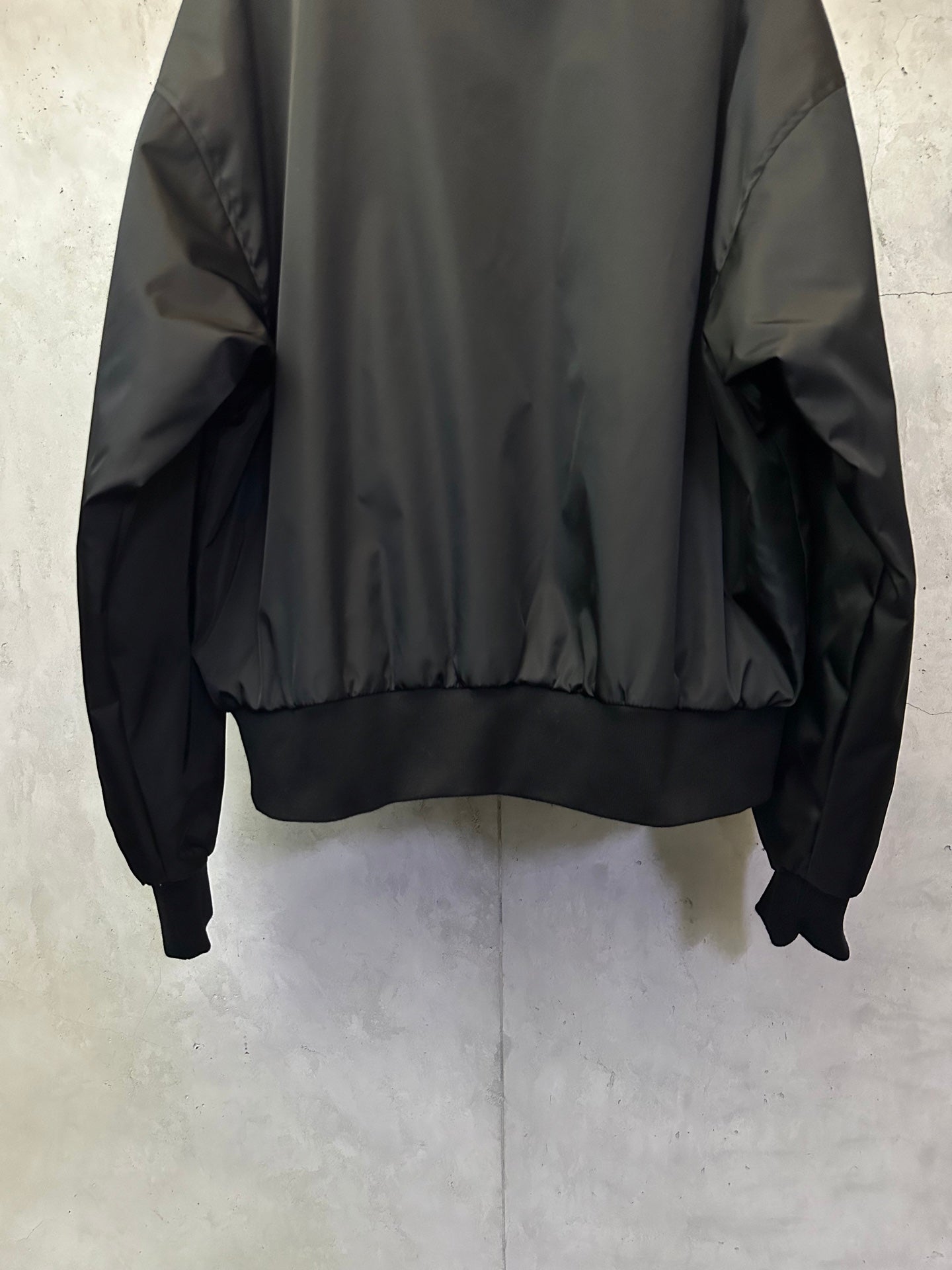 Black bomber jacket with ribbed cuffs and elastic hem band
