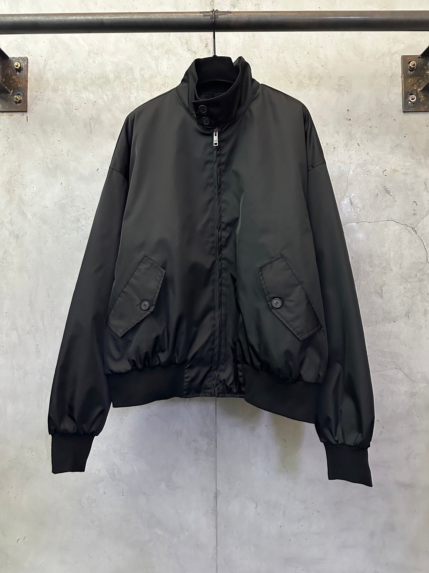 Black zip-front bomber jacket with stand collar and flap chest pockets