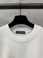 Cream crewneck T-shirt neckline with internal brand label