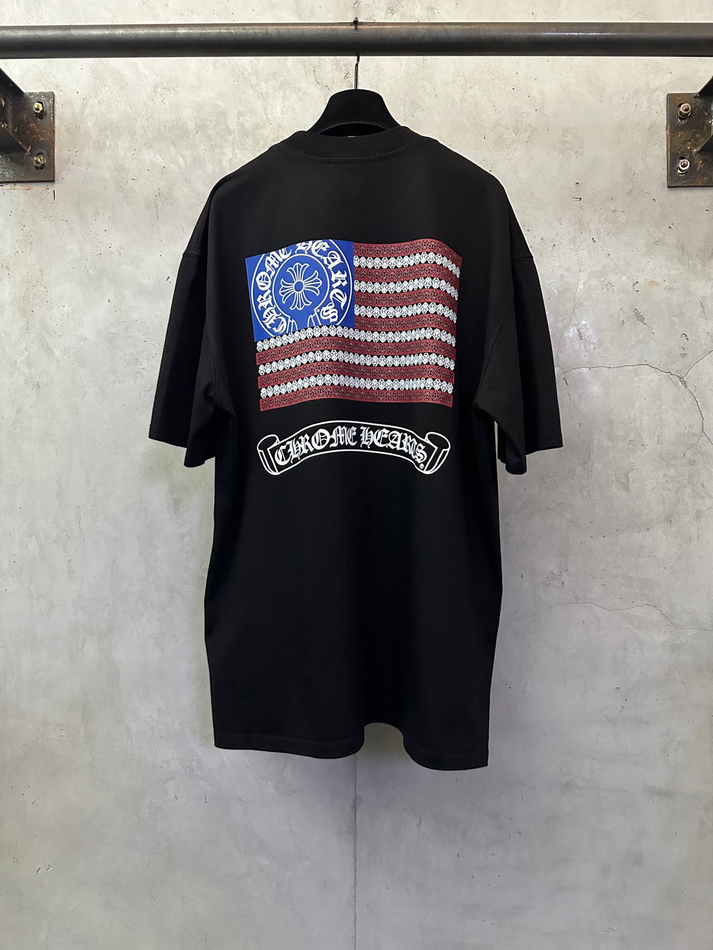 Black short-sleeve T-shirt with American flag striped back graphic and arched logo