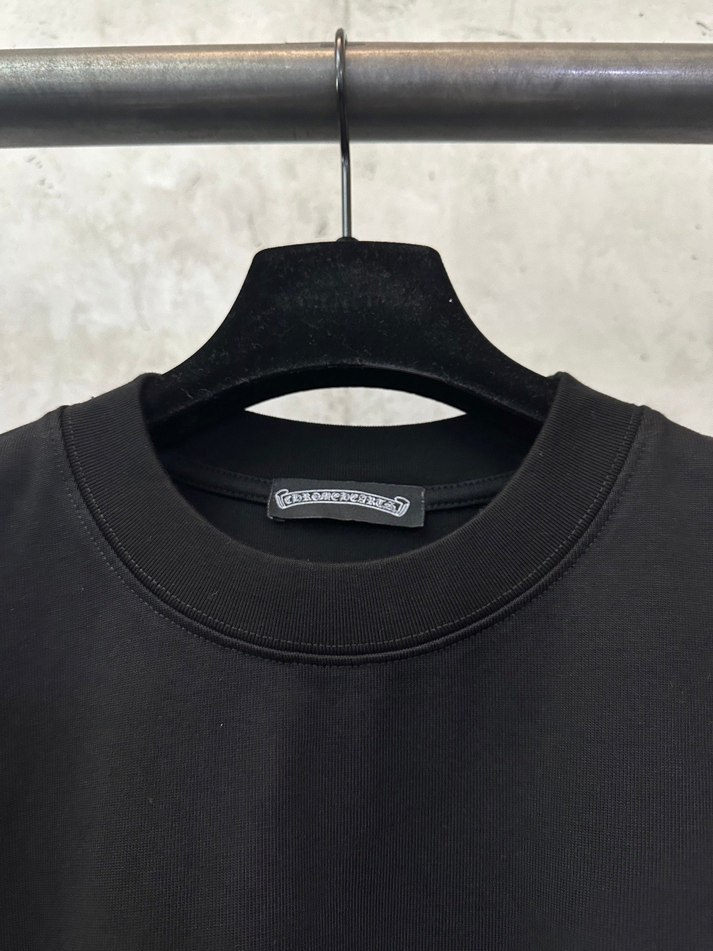 Black crew-neck T-shirt close-up with inner neck label