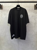 Black short-sleeve T-shirt with small circular chest graphic and crew neck
