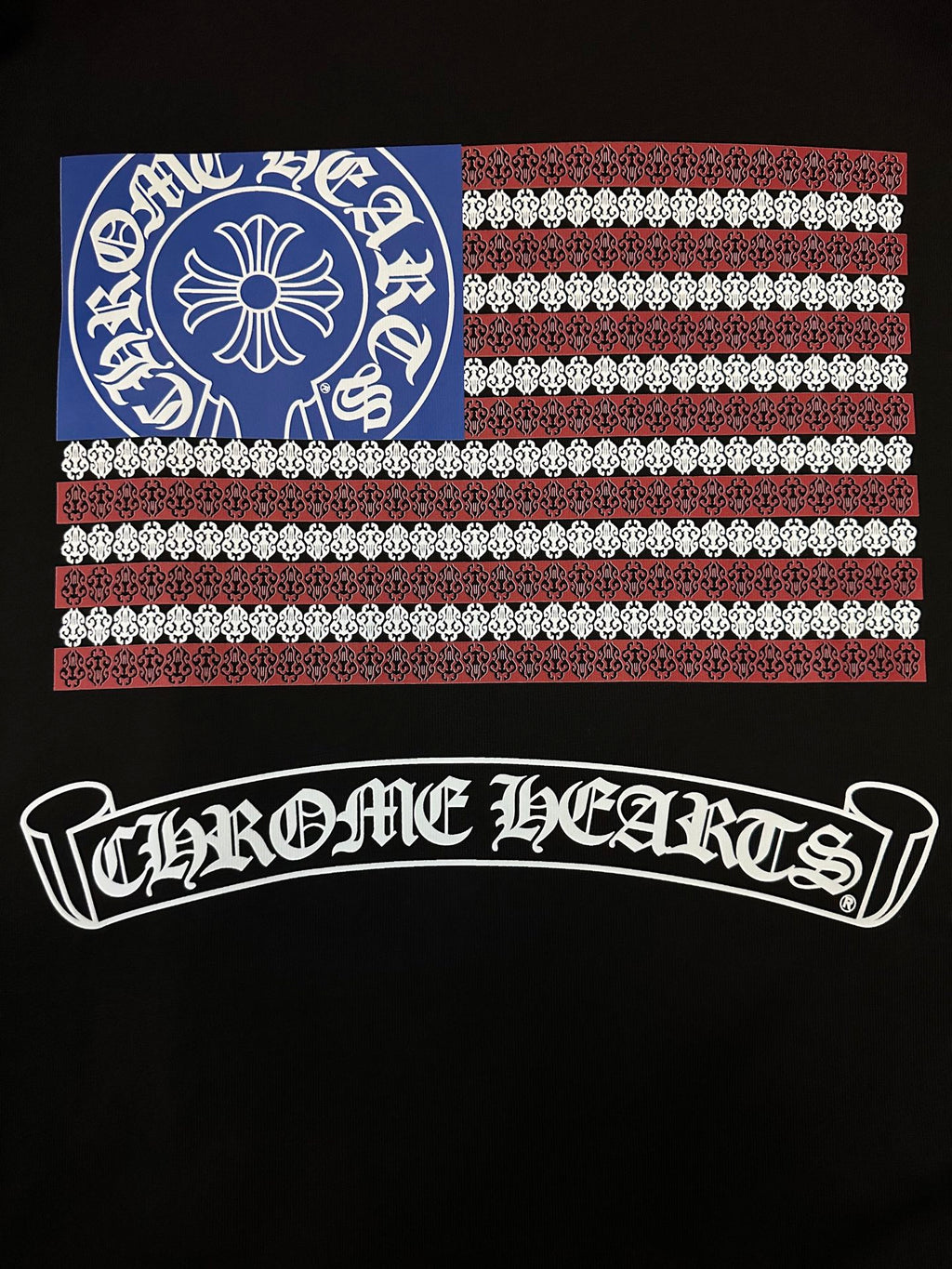 Black short-sleeve T-shirt close-up of back graphic: flag panel and arched logo