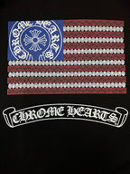 Black short-sleeve T-shirt close-up of back graphic: flag panel and arched logo