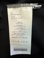 T-shirt care label with cotton and washing instructions inside neck seam
