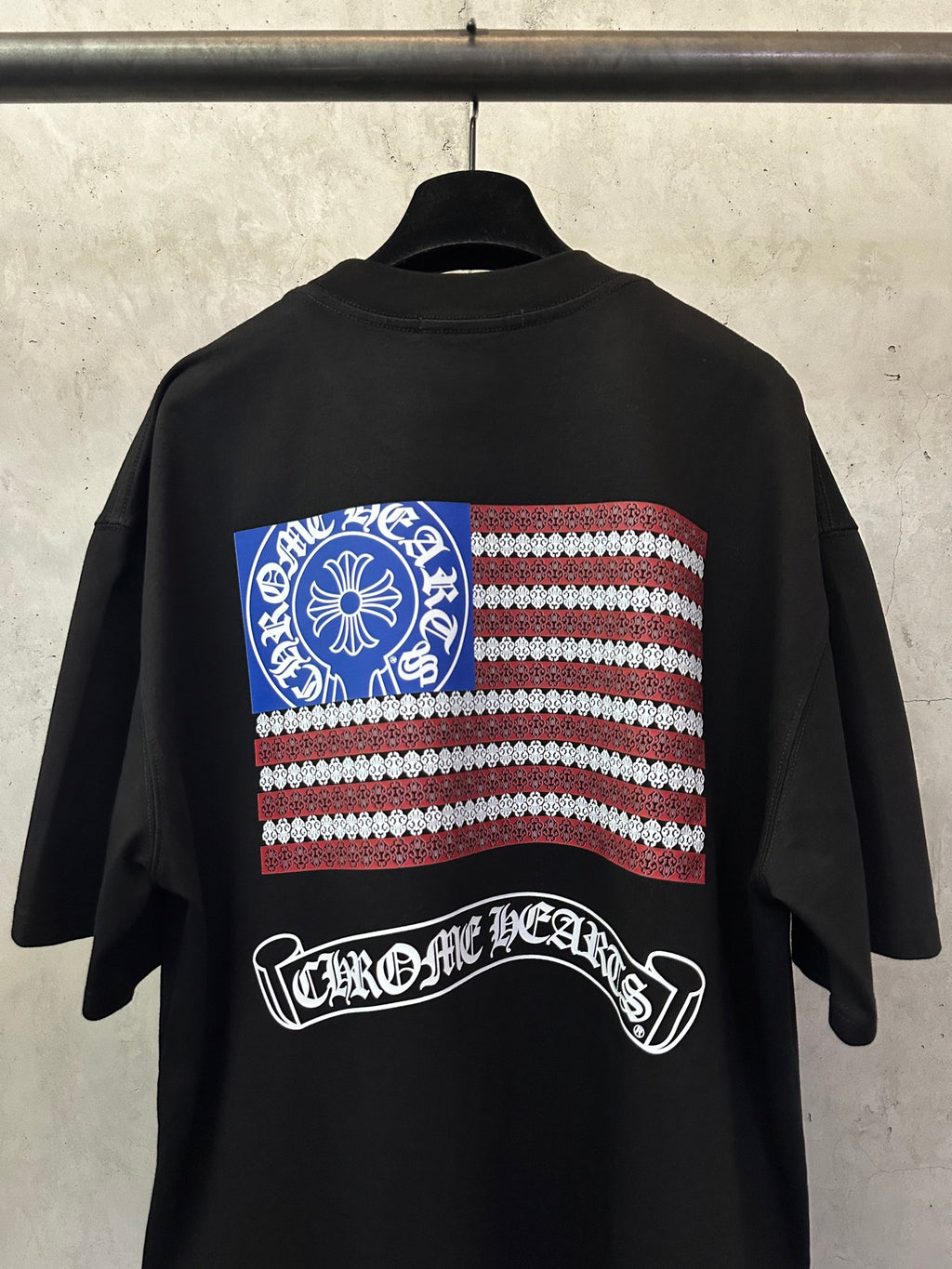 Black short-sleeve T-shirt with large back American flag graphic and arched logo