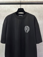 Black short-sleeve T-shirt with circular chest logo patch at center