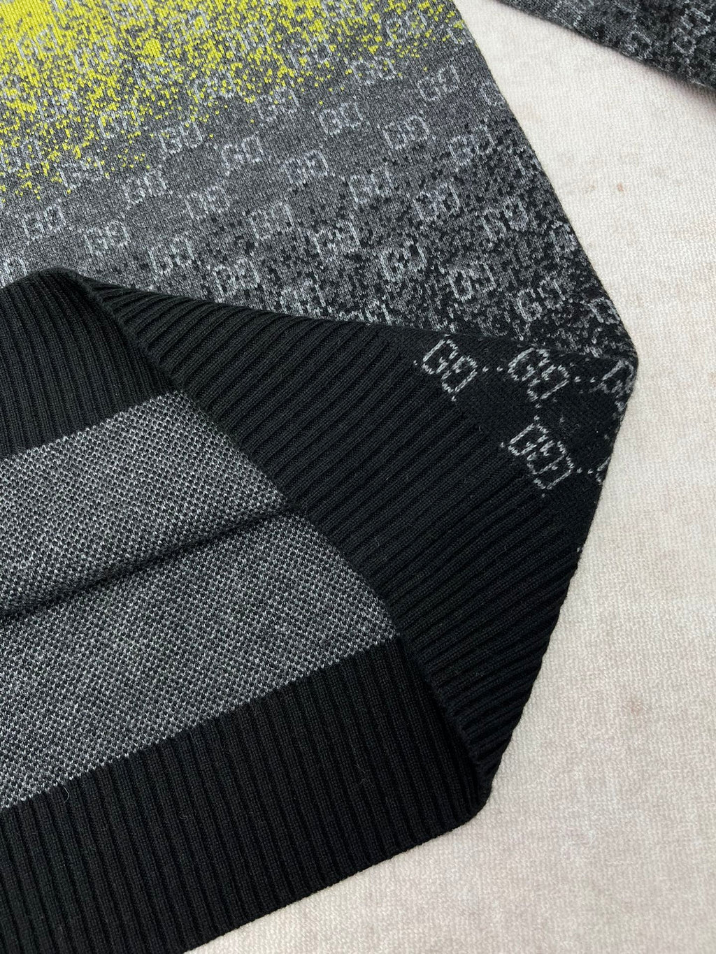 Dark knit sleeve detail with ribbed cuff and GG pattern