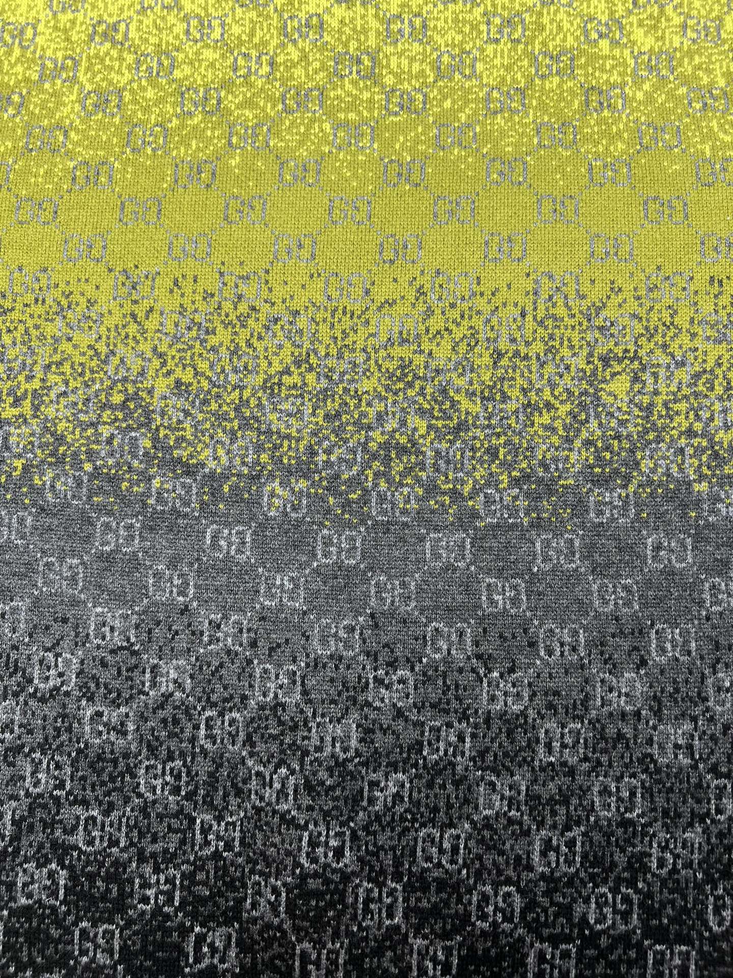 Yellow and dark gradient knit sweater with GG logo pattern close-up