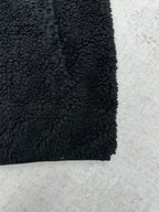 Dior black sherpa jacket hem close-up with curly textured fabric
