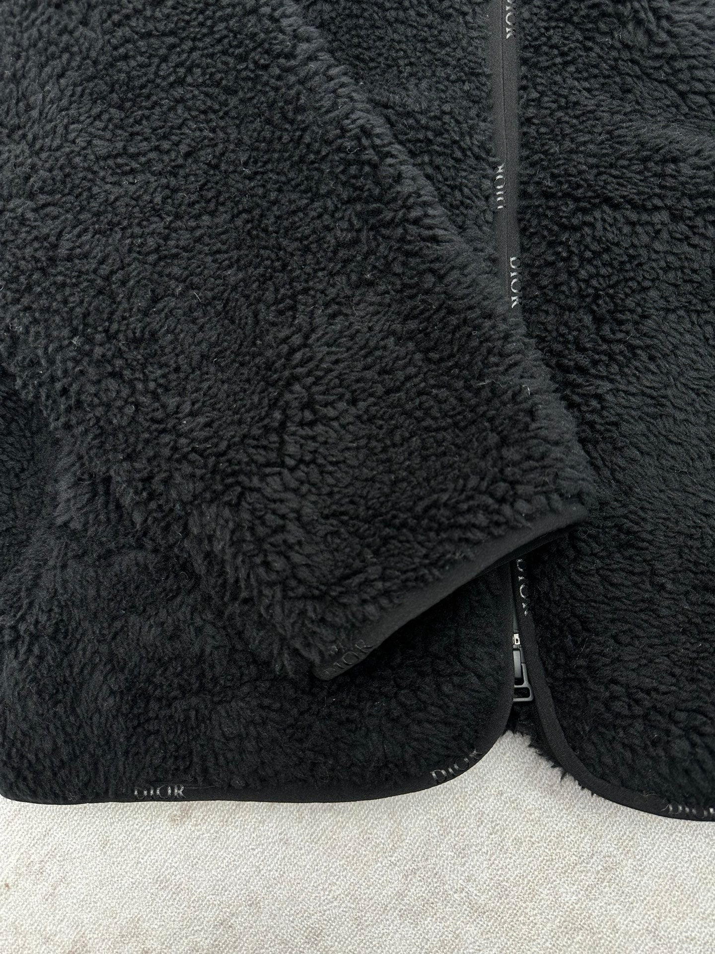 Dior black sherpa jacket side detail with zipper and textured fabric