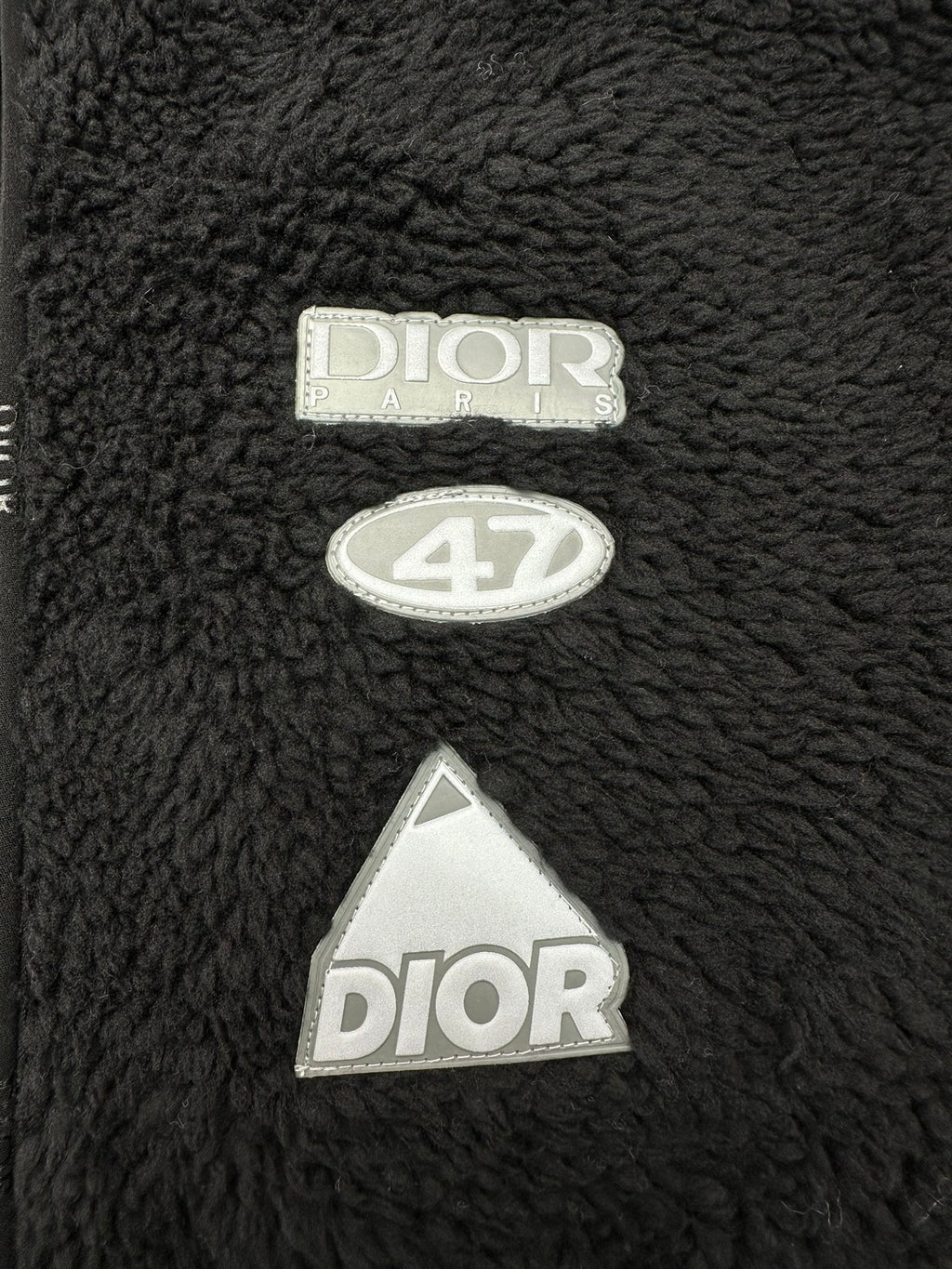 Dior black sherpa jacket with embroidered “Dior” logo and tag patches