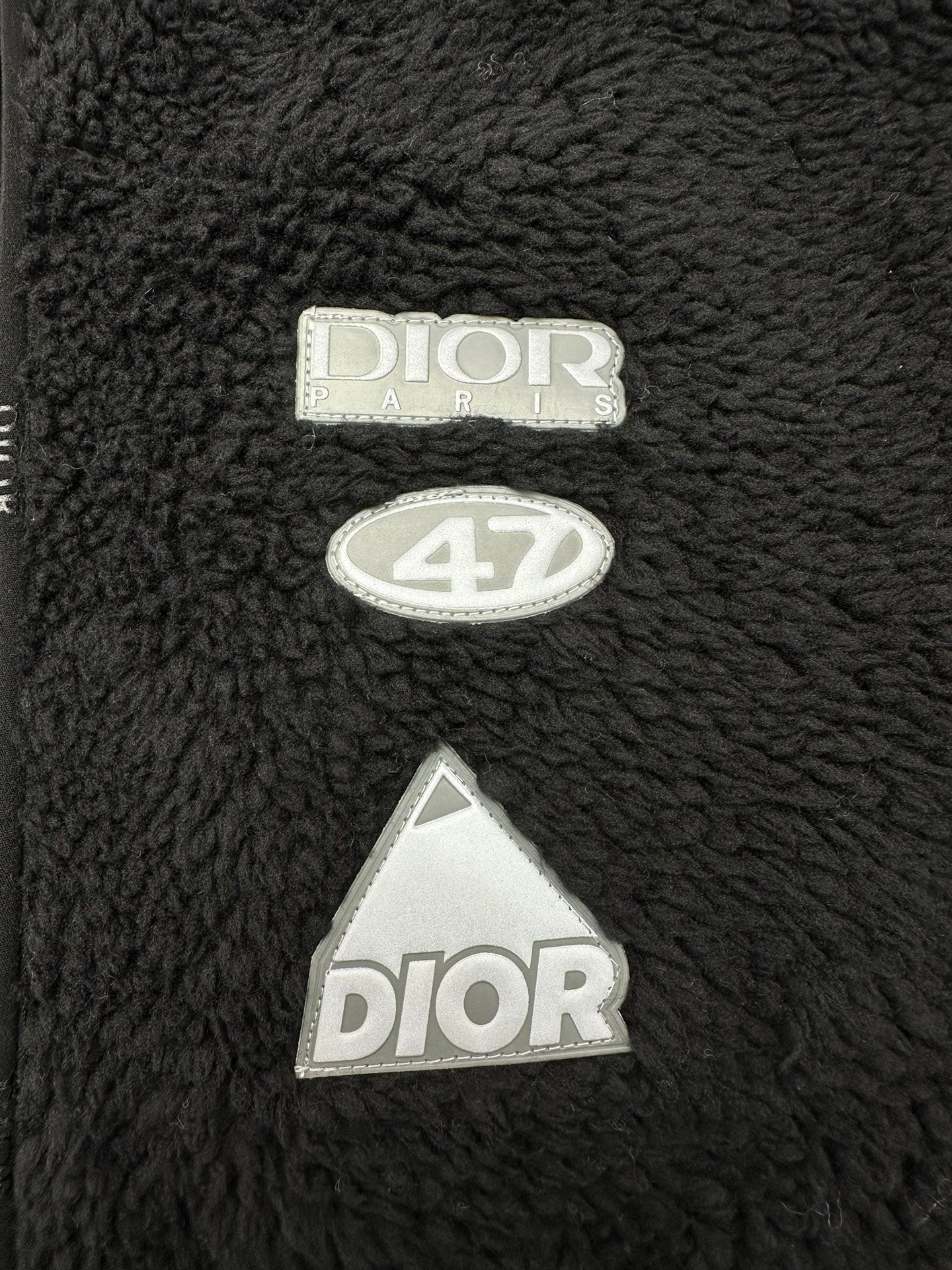 Dior black sherpa jacket with embroidered “Dior” logo and tag patches
