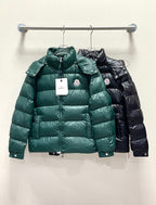 Moncler long puffer jacket, green front view on hanger with hood and zipper