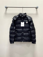 Moncler long puffer jacket, dark color front view on hanger with logo patch