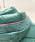 Dark green puffer jacket hood edge with red-and-blue trim detail