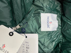 Dark green puffer jacket interior lining with white size label tag