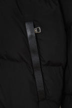 Black puffer jacket front with zipper and metal slider on textured placket