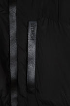 Black puffer jacket center placket with vertical textured label detail