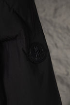 Long black Moncler jacket with circular logo patch