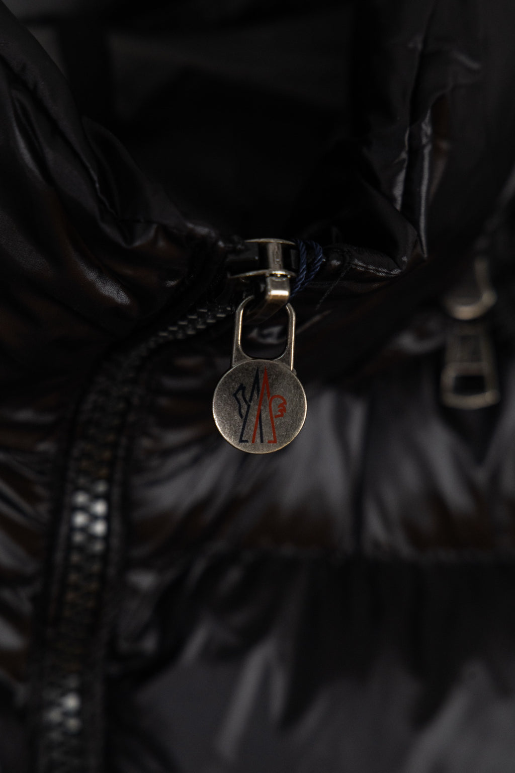 Moncler puffer jacket zipper pull with metal logo charm