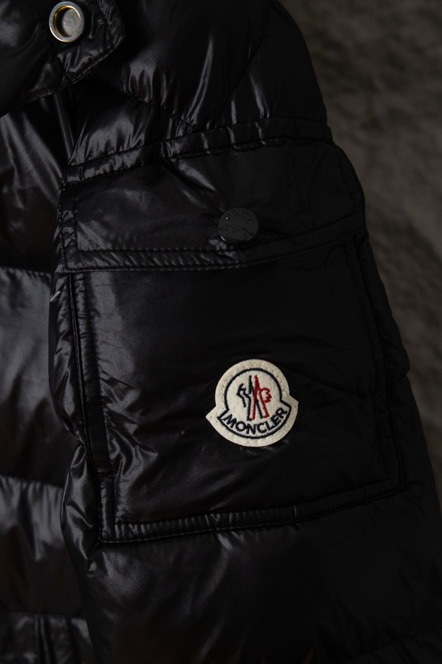 Moncler long puffer jacket front with round logo patch and flap pockets