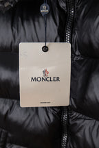 Moncler puffer jacket with hang tag over dark zipper placket