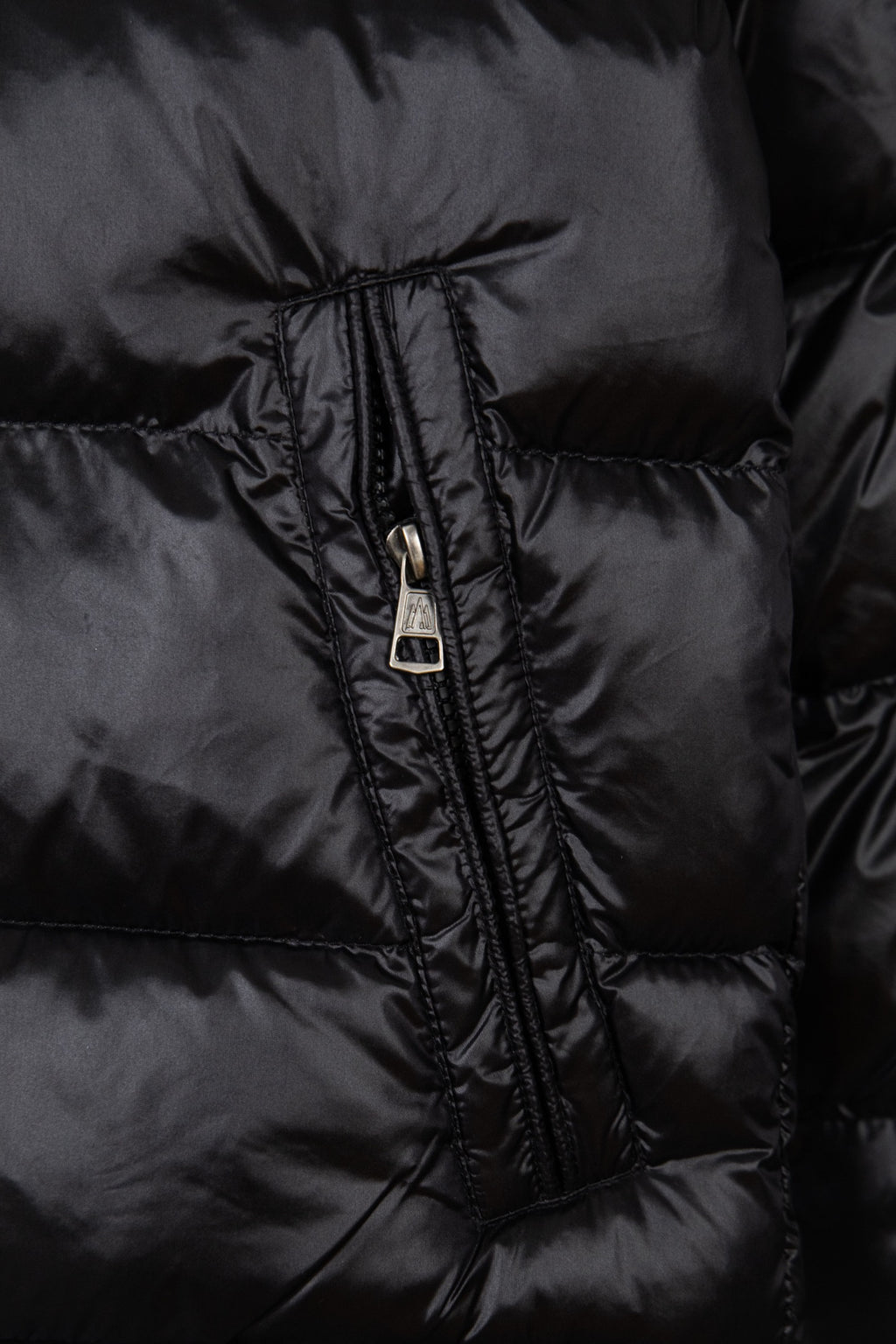 Moncler puffer jacket zipper close-up in dark fabric