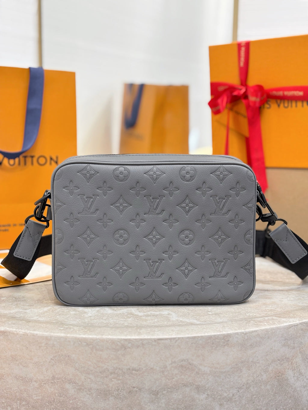 Louis Vuitton gray monogram crossbody bag with structured front and top zipper closure