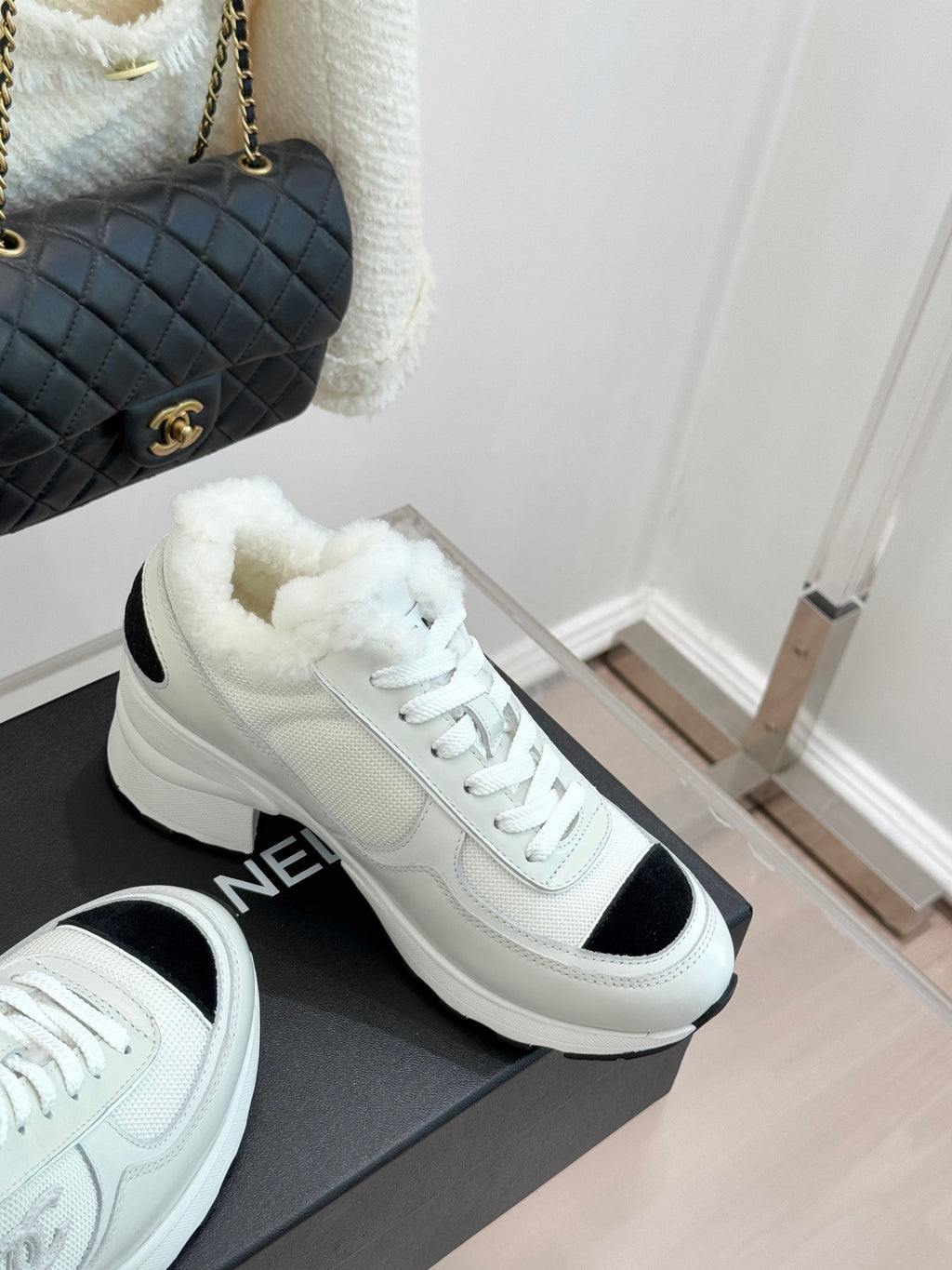 White chunky sneakers with black heel/side inserts and white lace-up design