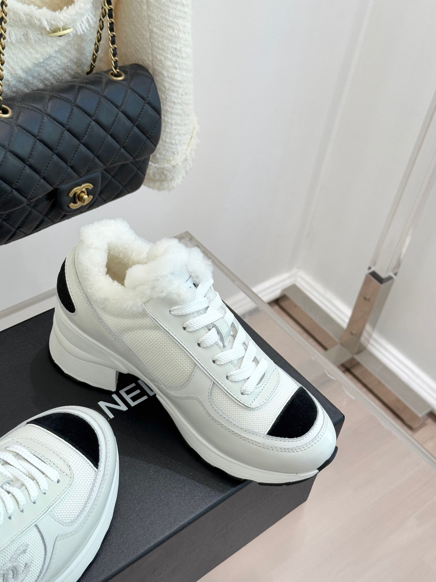 White chunky sneakers with black heel/side inserts and white lace-up design