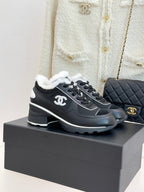 Chanel ladies sneakers, black with white logo accents and fuzzy white lining