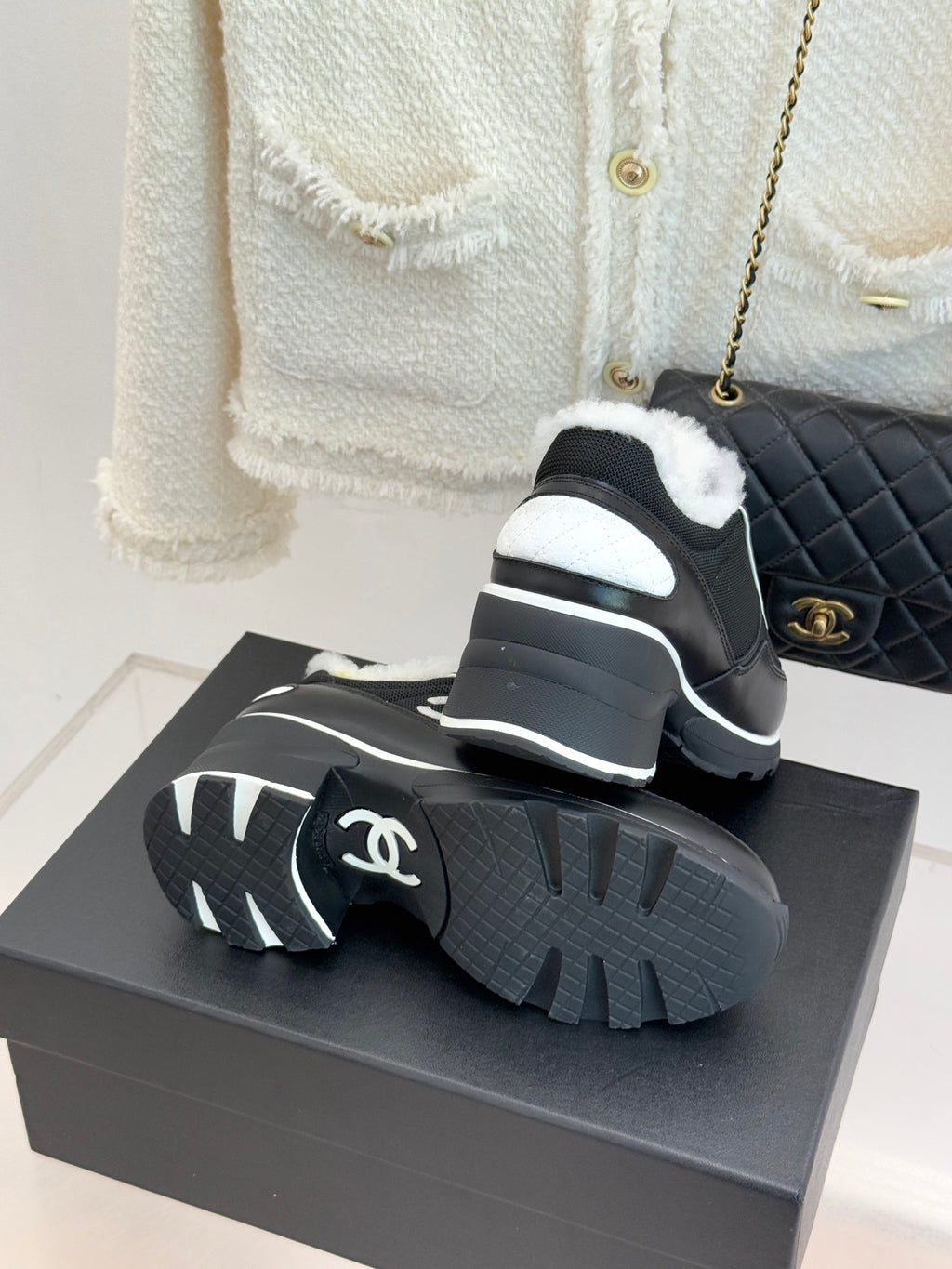 Chanel ladies sneakers showing tread, black outsole with white logo